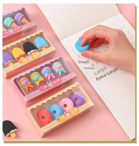 Close-up of cute dessert-shaped erasers set on a pink background with notebook scenery