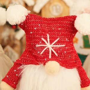 Close-up of a Christmas gnome with sparkling red sequin hat and white pom-pom details