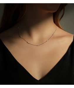 Close-up of elegant S925 sterling silver choker necklace with sparkling zircon on model