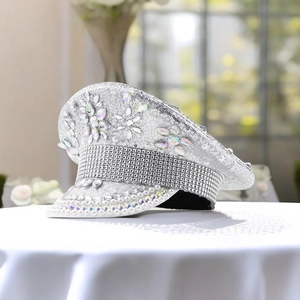 Close-up of silver sequined captain hat with floral gemstones, rhinestones and pearls