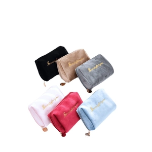 Plush embroidered makeup bags in six colors with gold zippers and beauty lettering
