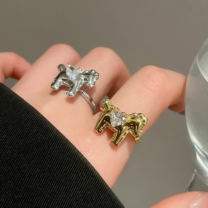 Macro shot of gold and silver horse rings featuring heart-cut cubic zirconia stones