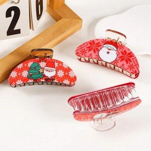 Three festive Christmas hair claws with Santa and snowman patterns on a clean background