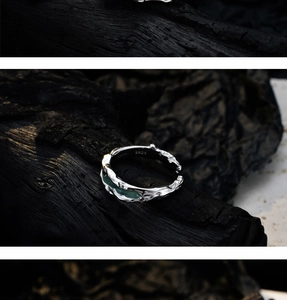 Macro detail of S925 sterling silver ring with lava texture and green enamel inlay