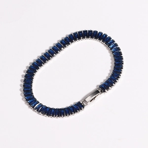 Close-up of baguette-cut blue zircon stones set in silver metal tennis bracelet