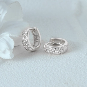 Detailed macro view of S925 sterling silver huggie earrings with double row paved zircons