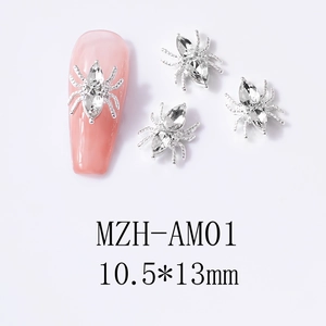 Silver spider nail art charms with rhinestones and 10.5x13mm size on pink nails