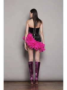 Rear view of a sexy corset dress with pink pleated feathers and metallic purple boots