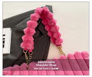 Detail showing plush pink tote strap with fluffy pompom and gold chain link accents