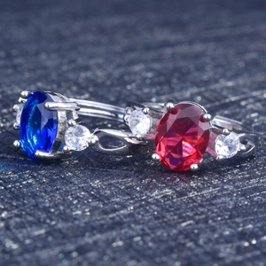 Elegant adjustable silver rings featuring large oval sapphire and ruby style gemstones