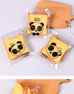 Detail of transparent bread bags with cute panda patterns and bakery text packaging