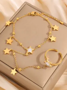 Detailed close-up of a gold star finger bracelet set with white star inlay accents