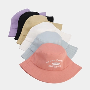 Close-up of colorful cotton bucket hats with letter embroidery in various trendy shades