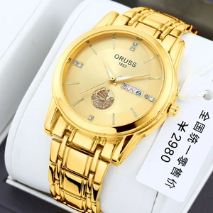 Men's gold quartz watch with sailboat relief and diamond markers on white pillow