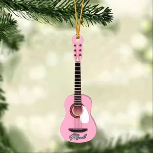 Detailed view of pink acrylic guitar ornament with Mark lettering on a Christmas tree
