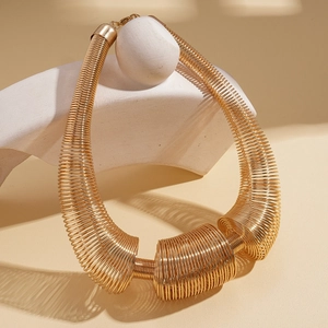 Exaggerated golden spring coil metal necklace with a bold geometric industrial style