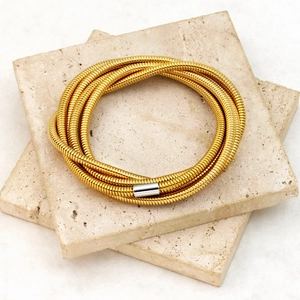 Minimalist 18K gold plated stainless steel multi-layered snake bracelet on stone tiles