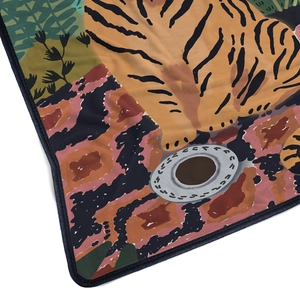 Detailed close-up of flannel blanket showing Tiger art print and neat navy hem stitching