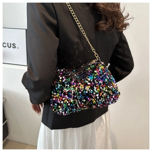 Detail of colorful sequins handbag with elegant golden chain strap shown on shoulder