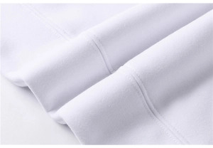 Close-up of high-density white knitted cotton fabric and dual-needle stitching on cuff