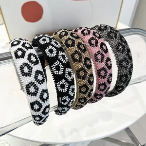 Detailed view of five handcrafted leopard print beaded headbands in various stylish colors