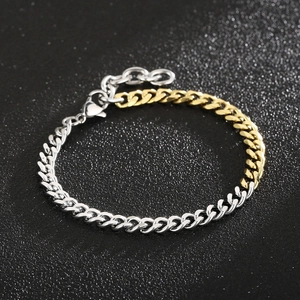 Close-up of dual-tone gold and silver Cuban chain link bracelet with lobster clasp