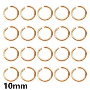 Detailed view of twenty 10mm golden jump rings for DIY jewelry making in a neat 4x5 grid