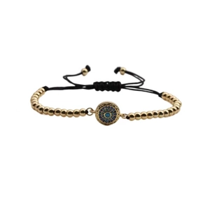 Bohemian gold beaded bracelet with blue evil eye pendant on adjustable black cord