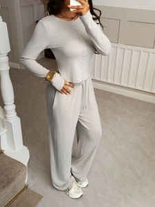 Detail view of gray ribbed knit loungewear set featuring button shirt and wide-leg trousers