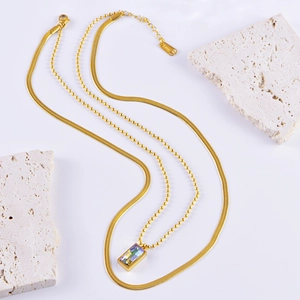 Double-layered stainless steel necklace featuring a gold snake chain and iridescent pendant