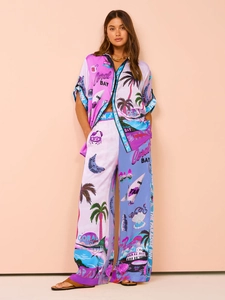 Detail of silk-texture tropical print two-piece set featuring short sleeve shirt and wide pants