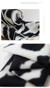 Detailed texture of soft cow print scarf fabric and elegant pearl accessory pairing