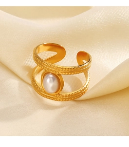 Macro shot of gold-plated double-layer ring featuring a white faux pearl on silk