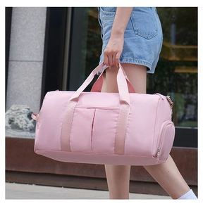 Pink fitness bag detail showing wet-dry separation pocket and waterproof fabric