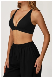 Detail of black V-neck sports bra and matching high-waist wide-leg yoga pants set