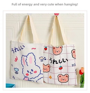 Detail view of cute canvas tote bags featuring cartoon rabbit and bear illustrations