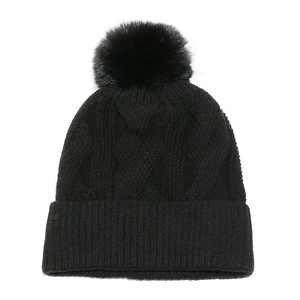Detailed view of black cable knit beanie with faux fur pom-pom and ribbed cuff detail