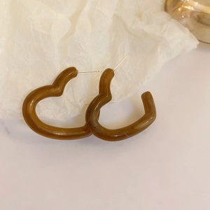 Elegant amber heart-shaped resin earrings with irregular geometric silver needle posts