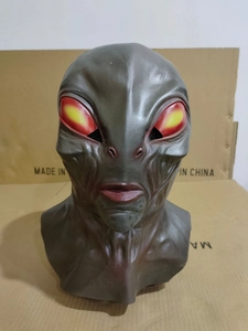 Detailed close-up showing bionic skin textures and red eyes of the alien mask