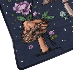 Detailed view of plush flannel blanket with vintage mushroom and rose pattern embroidery
