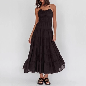 Elegant black halter tiered maxi dress with textured fabric for a summer vacation look