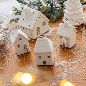 Set of four white ceramic mini house ornaments with gold details for Christmas decor