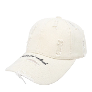Detail of distressed embroidery on vintage washed cotton baseball cap with torn brim