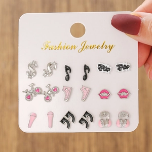 Detailed close-up of a 9-pair set of colorful enamel stud earrings on a white display card