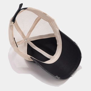 Detail view of the breathable mesh back and distressed brim of this trucker baseball cap