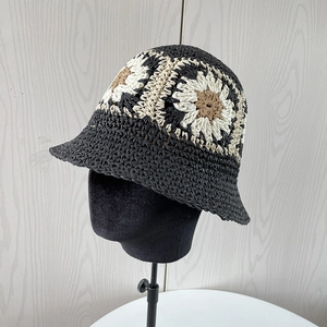 Detailed view of handmade crochet straw hat with vintage floral patterns and woven texture