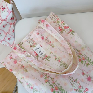 Close-up of pink floral canvas tote bag featuring premium fabric and stitched label