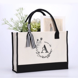 Beige cotton canvas tote bag with black trim, summer vibe print, and striped ribbon detail