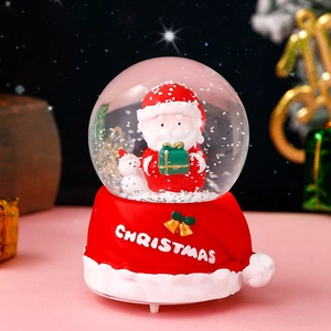 Christmas glow crystal ball with Santa Claus and cat inside on festive gift box base
