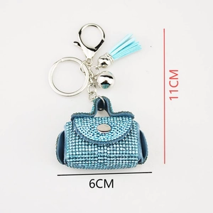 Close-up of blue rhinestone mini bag keychain with light blue tassel and dimensions